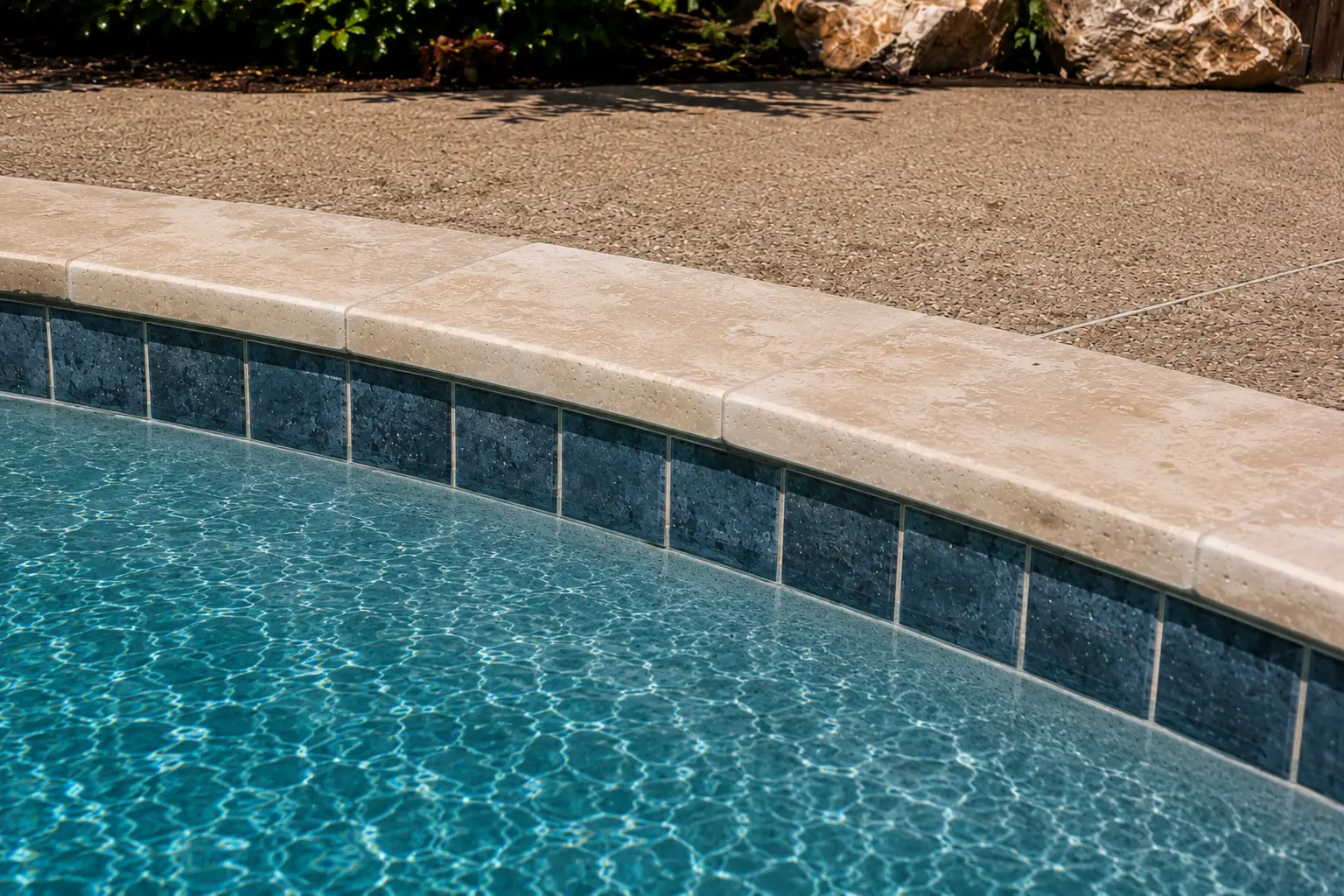 New waterline tile and travertine coping on a remodeled North Texas pool