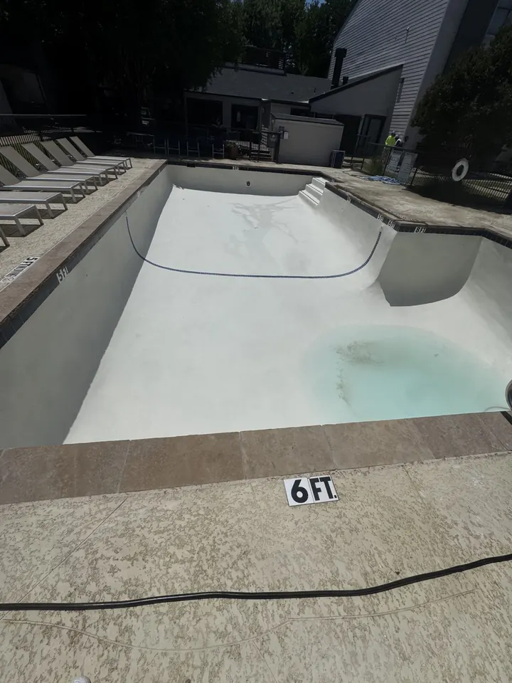 Rectangular pool with fresh white plaster being filled in Grapevine, TX